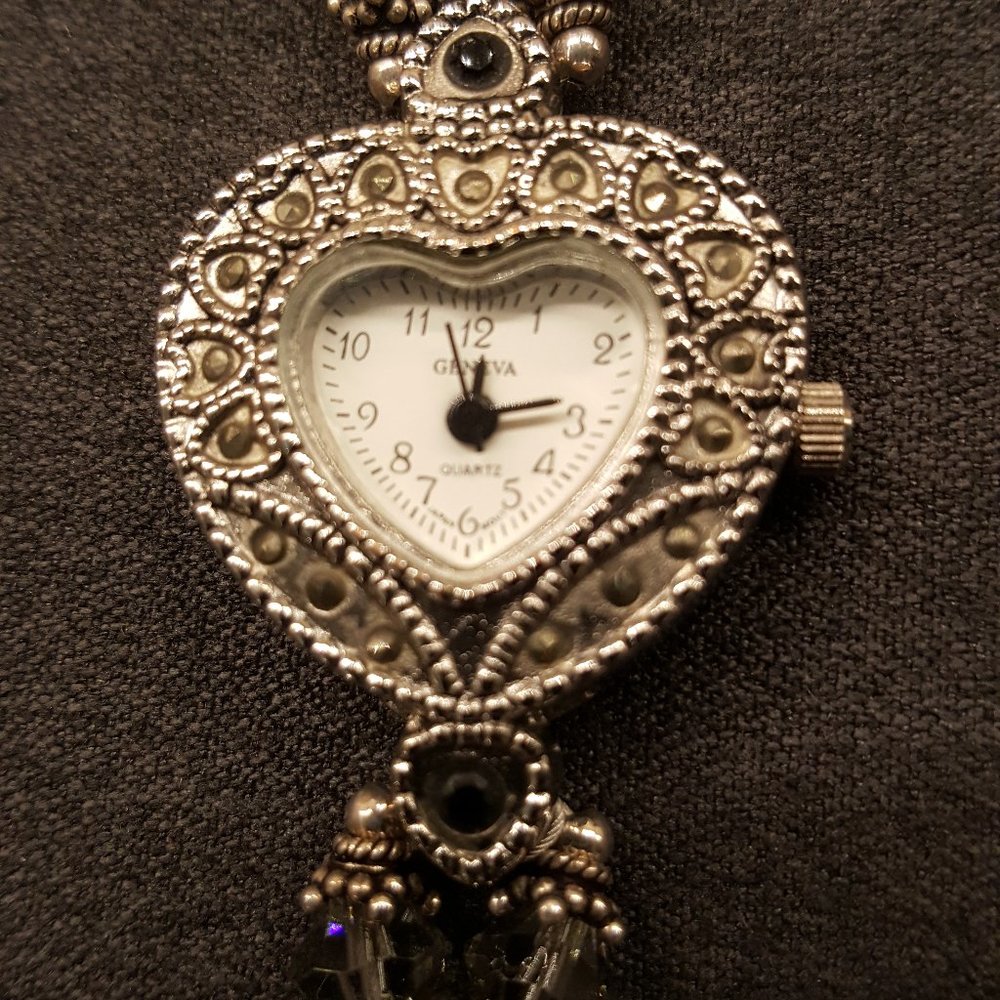 Bracelet watch with heart shaped watch face.